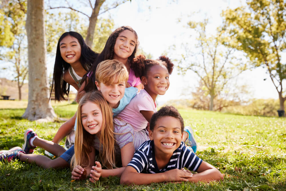 group of multiethnic children in grass